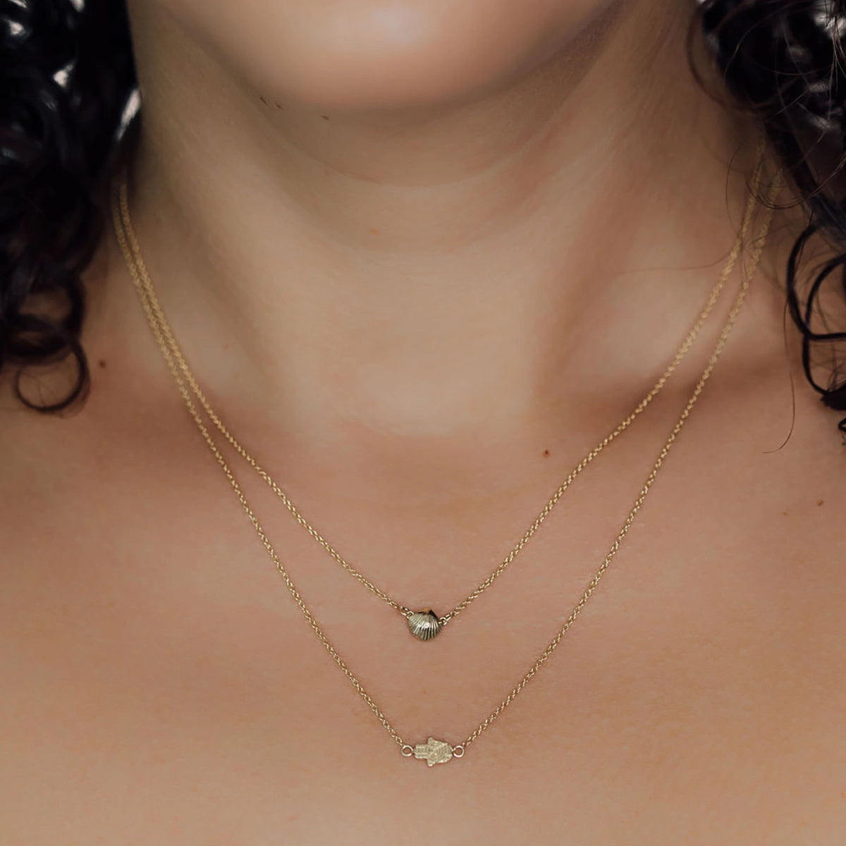 14K Gold Mini Seashell Necklace and Mini Hamsa Necklace - Daphna Simon Jewelry
